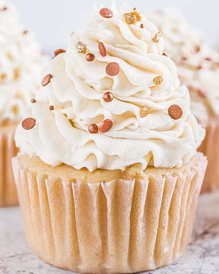 These Bourbon Vanilla Cupcakes are perfectly moist, and completely irresistible!  Light and fluffy cupcakes are spiked with bourbon and swirled with creamy vanilla buttercream for the ultimate dessert. #cupcakes #baking #dessert #vanilla #bourbon #fallbaking #dessertrecipe