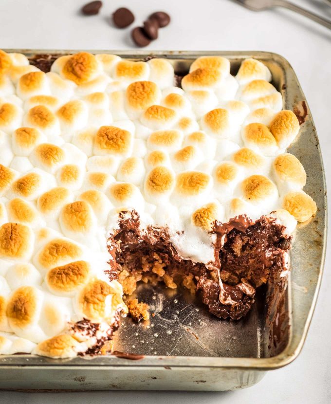 This ooey-gooey Caramel S'mores Cookie Cake has a buttery graham cracker/sugar cookie base, and is topped with melted chocolate and caramel, then topped with delicious toasted marshmallows!  It's the summer dessert you just can't resist!