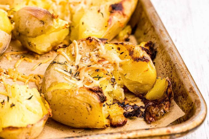 closeup view of crispy smashed potato on baking sheet