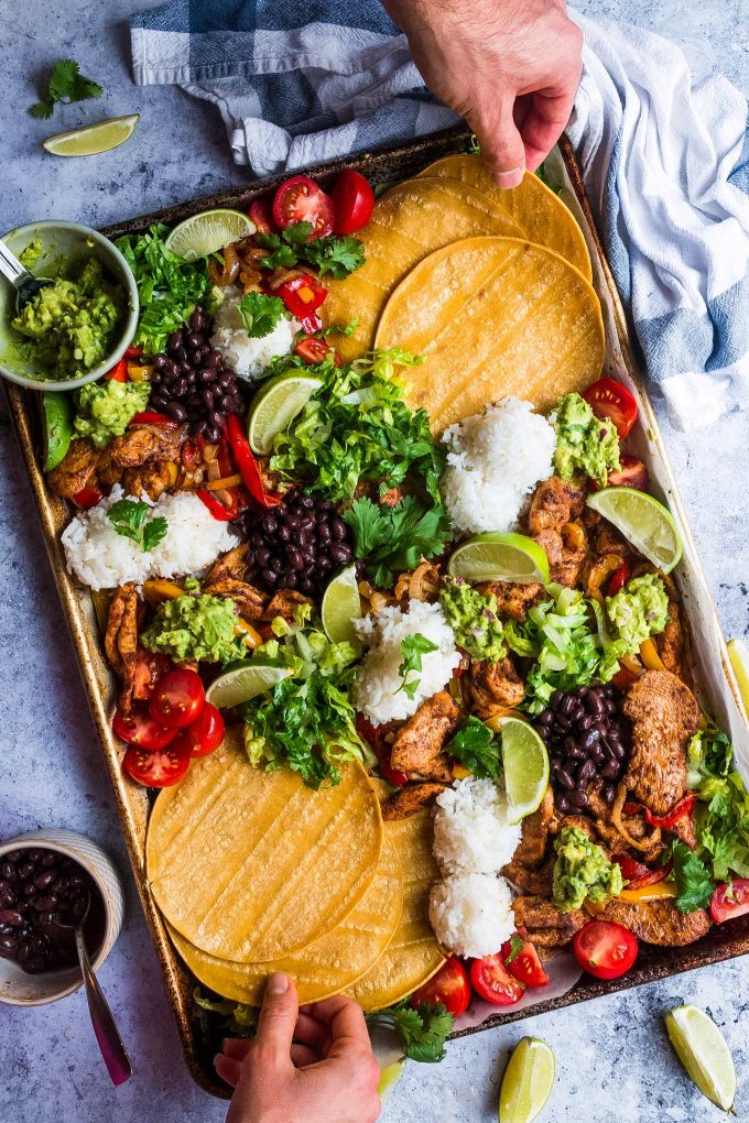 sheet pan of chicken fajitas with tortillas