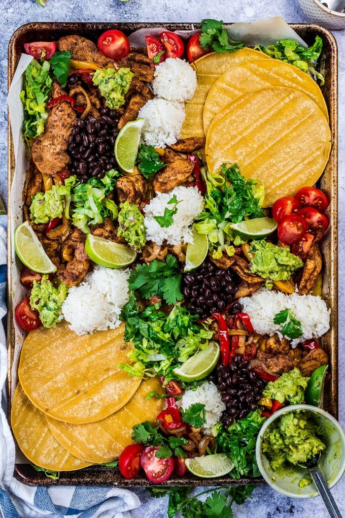 All the flavor of chicken fajitas, made easily on one sheet pan!  For a delicious dinner idea, add your favorite toppings right on the sheet pan and let your family make their own fajita tacos! 