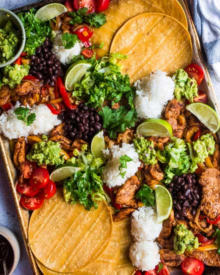 All the flavor of chicken fajitas, made easily on one sheet pan!  For a delicious dinner idea, add your favorite toppings right on the sheet pan and let your family make their own fajita tacos! 