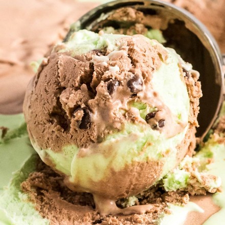 close up view of a scoop of chocolate and mint swirled ice cream