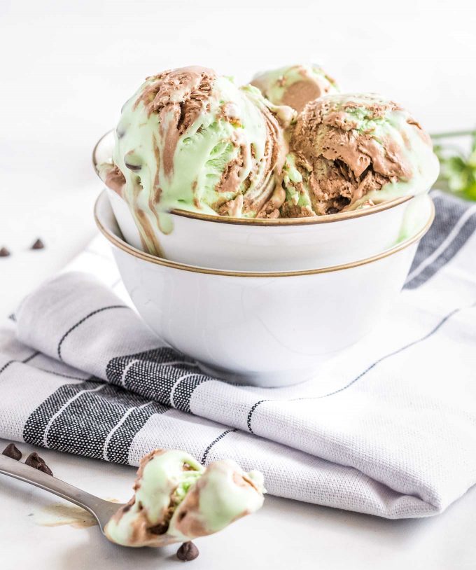 white bowl full of mint chocolate chip ice cream