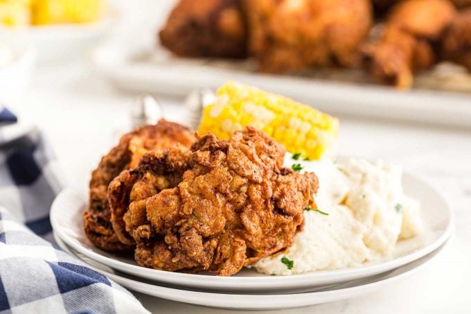 fried chicken on plate with mashed potatoes and corn