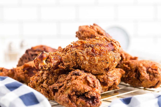 pile of fried chicken on cooling rack