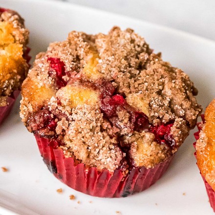 cranberry orange muffin on white plate