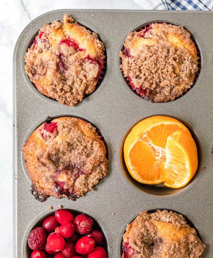 cranberry orange muffins in baking pan with fruit