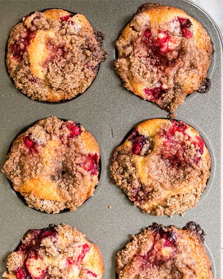 These Cranberry Orange Muffins are made with tart cranberries, bright orange zest, and sweet freshly squeezed orange juice folded gently into a thick and rich classic muffin batter. Perfect for the holidays, school mornings, or anytime! #muffins #cranberry #orange #breakfast #dessert #easyrecipe #baking