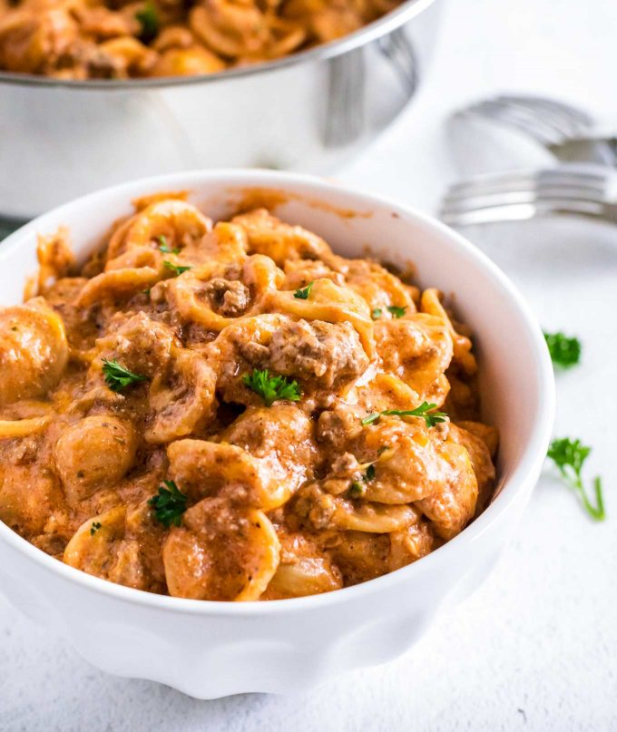 bowl of beef and shells pasta with parsley on top