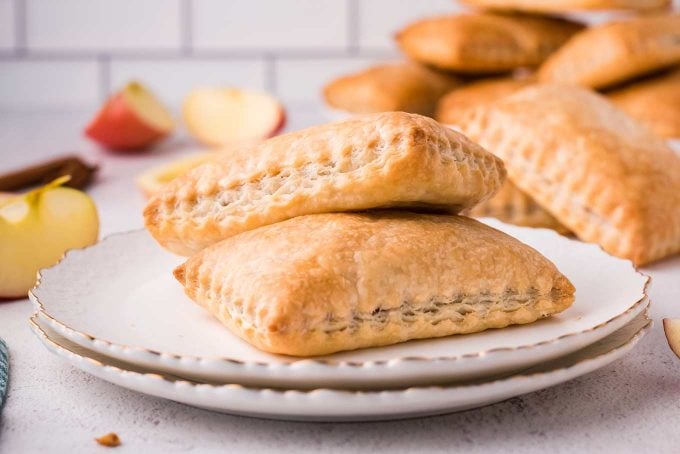 stack of apple turnovers on white plate