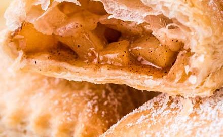 These homemade Apple Turnovers are filled with a spiced apple filling and baked in flaky, buttery puff pastry dough. Dust with powdered sugar or drizzle with glaze, and you have a breakfast that tastes like apple pie! #turnover #apple #applepie #applecinnamon #pastry #breakfast #dessert #baking