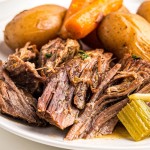 beef and vegetable pot roast on white plate