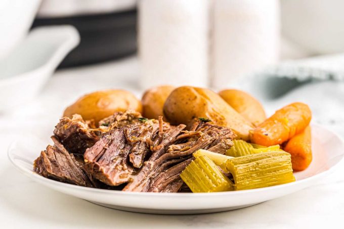 pot roast with vegetables on white plate