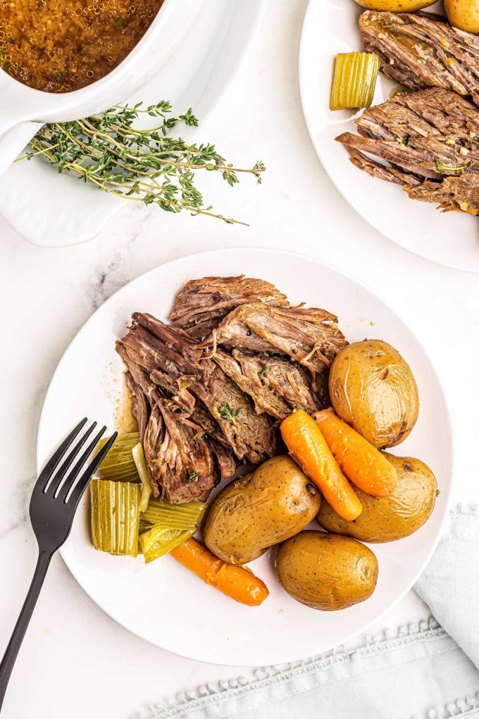 Juicy, melt-in-your-mouth beef, tender vegetables and an ultra flavorful gravy make for the perfect Pot Roast recipe! Classic comfort food meets family friendly dinner, made with the ease of the Instant Pot! #potroast #beef #instantpot #pressurecooker #dinner #comfortfood #potroastrecipe