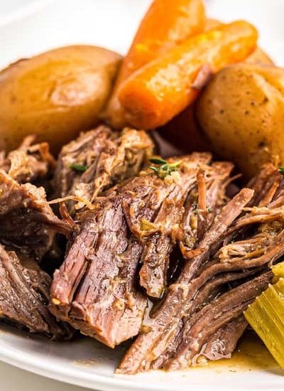Juicy, melt-in-your-mouth beef, tender vegetables and an ultra flavorful gravy make for the perfect Pot Roast recipe! Classic comfort food meets family friendly dinner, made with the ease of the Instant Pot! #potroast #beef #instantpot #pressurecooker #dinner #comfortfood #potroastrecipe
