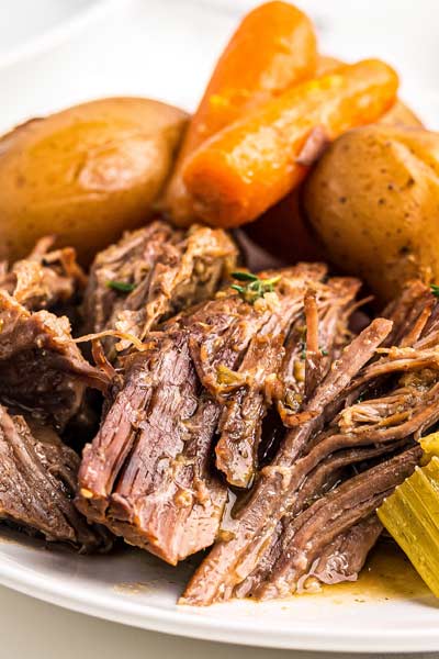 Juicy, melt-in-your-mouth beef, tender vegetables and an ultra flavorful gravy make for the perfect Pot Roast recipe! Classic comfort food meets family friendly dinner, made with the ease of the Instant Pot! #potroast #beef #instantpot #pressurecooker #dinner #comfortfood #potroastrecipe