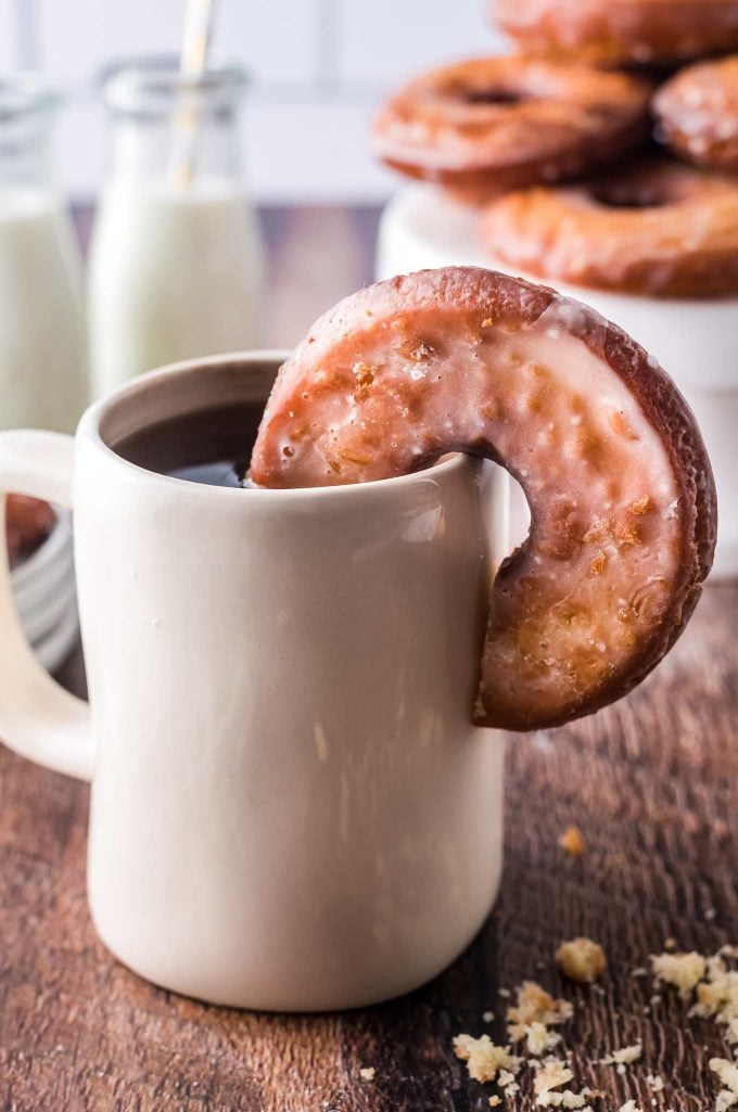 Donut on side of coffee cup