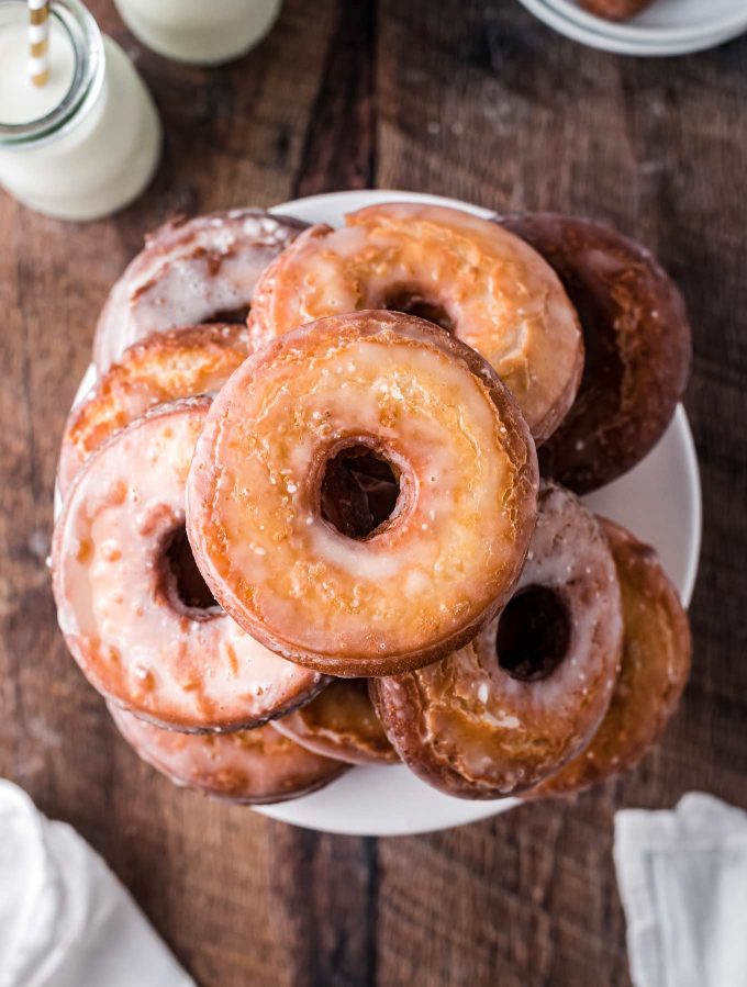 overhead view of stack of cake donuts on white plate