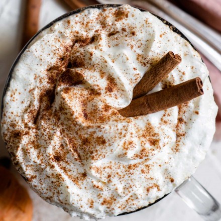 top down view of pumpkin spice latte with cinnamon sticks