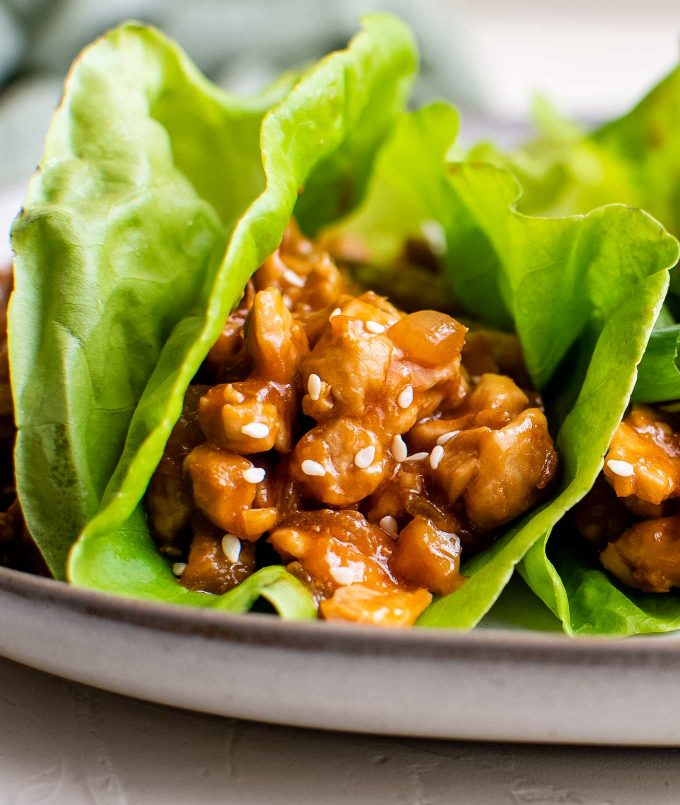 These easy Asian-Style Chicken Lettuce Wraps are SO flavorful, and perfect as a simple dinner recipe, or an appetizer for a party! #chicken #asian #chinese #lettucewraps #lettucecups #chickendinner #dinner #lunch #appetizer #party