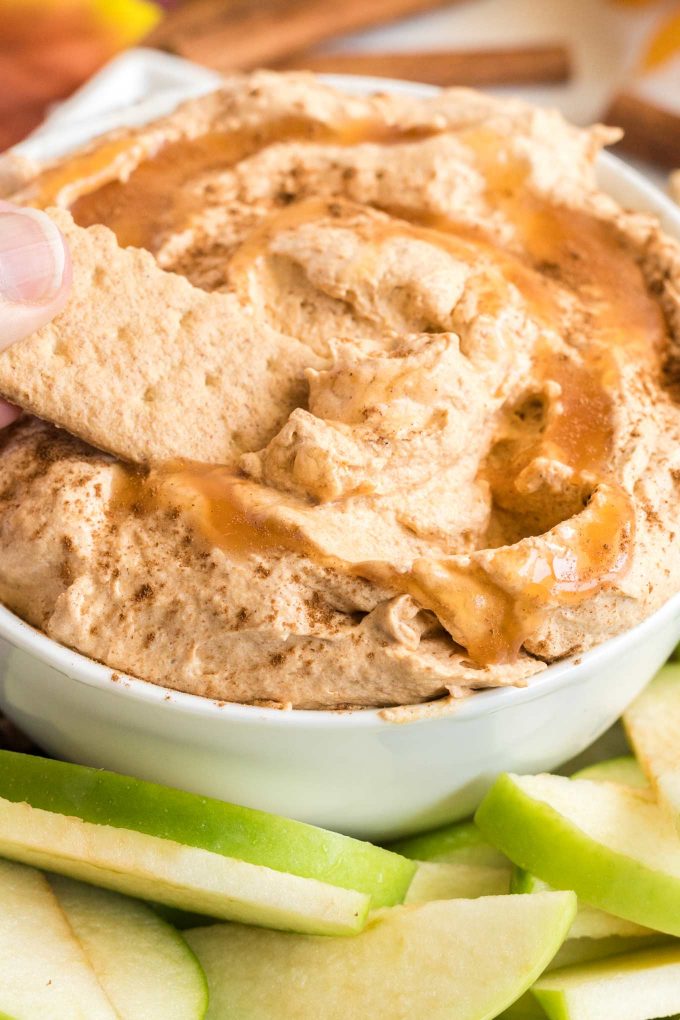 dipping graham crackers into pumpkin pie dip