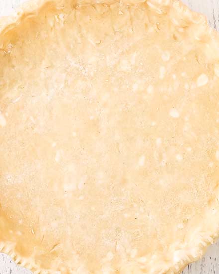 Learn how to make the most incredible and flaky pie crust!  Once you make this pie crust from scratch you'll never want to use those pre-made crusts again.  Save this recipe for every holiday! #pie #piecrust #homemade #piedough #fromscratch #baking #basicrecipe #holiday #butter #shortening