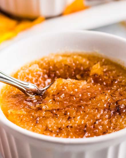 This Pumpkin Creme Brulee recipe is the perfect make-ahead fall dessert!  I promise it's easier to make than you think; just 5 simple ingredients give you a creamy custard topped with a crackly caramelized sugar topping! #cremebrulee #pumpkin #dessert #baking #makeahead #falldessert #fallbaking #custard