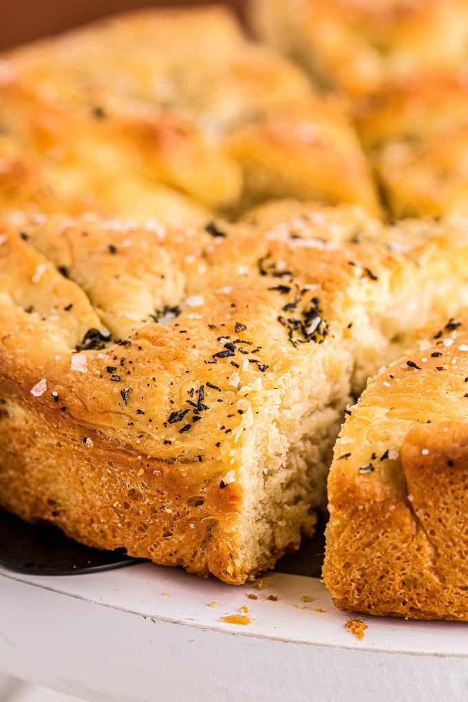 pulling out a slice of focaccia bread