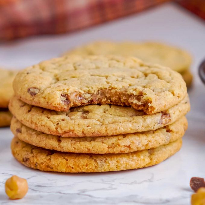 stack of pumpkin cookies, one with a bite taken out of it