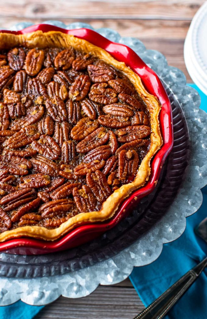 This Bourbon Chocolate Pecan Pie recipe is a fun twist on a classic Fall dessert, and a MUST for any Thanksgiving table.  The gooey, sugary center, warm oak-y flavor of the bourbon and decadent dark chocolate, and the crisp nutty top make this the ultimate holiday dessert! #pecanpie #pecan #chocolate #bourbon #thanksgiving #holiday #dessert #baking