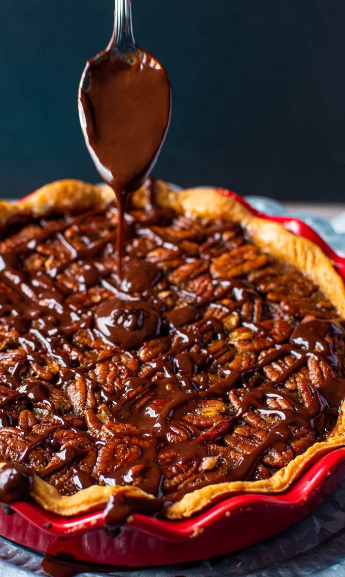 This Bourbon Chocolate Pecan Pie recipe is a fun twist on a classic Fall dessert, and a MUST for any Thanksgiving table.  The gooey, sugary center, warm oak-y flavor of the bourbon and decadent dark chocolate, and the crisp nutty top make this the ultimate holiday dessert! #pecanpie #pecan #chocolate #bourbon #thanksgiving #holiday #dessert #baking