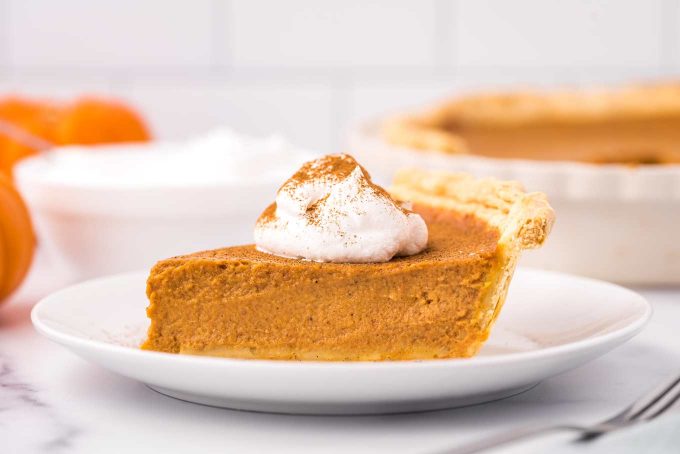 slice of pumpkin pie on white plate