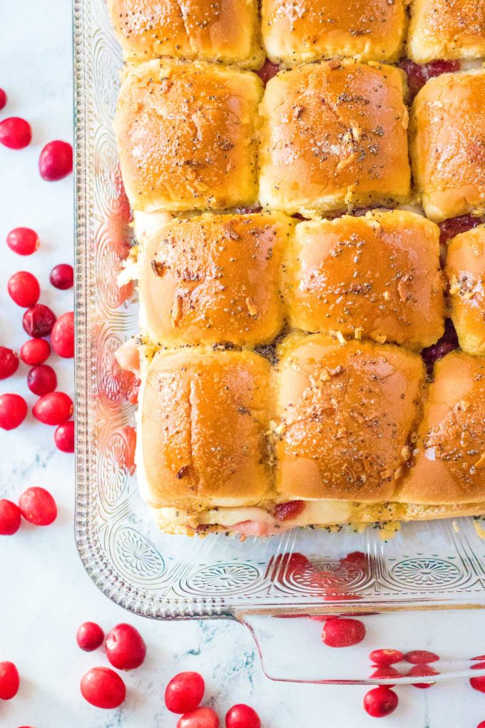 Looking for a great way to use up that leftover holiday ham? Try making these crowd pleasing Cranberry Ham Sliders!  Perfect with deli ham too, these quick and easy little Hawaiian roll sandwiches are a true family favorite! #ham #sliders #cranberry #leftovers #holiday #thanksgiving #christmas #hawaiianrolls
