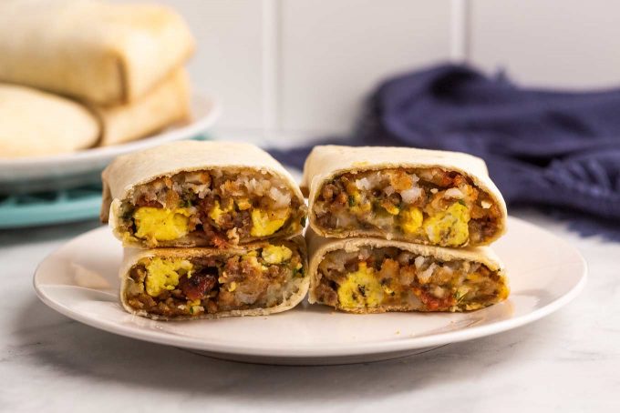 two breakfast burritos sliced in half