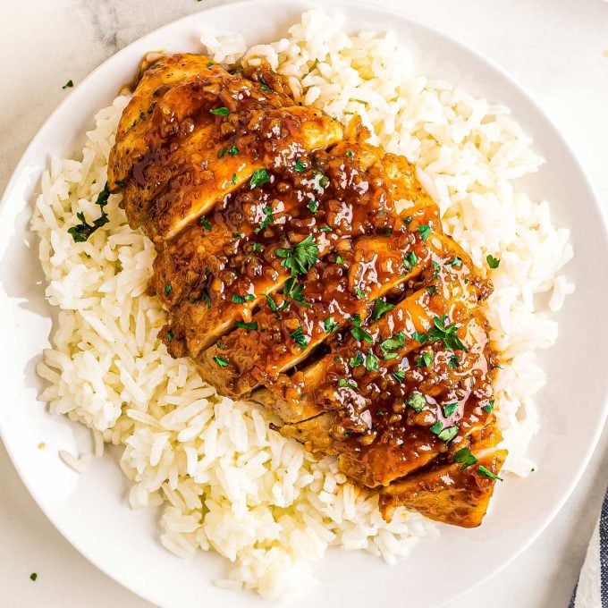 sliced honey garlic chicken breast on top of rice