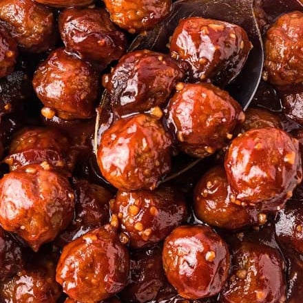 These crowd-pleasing tender meatballs are smothered in a super flavorful honey garlic bbq sauce.  Perfect for parties, this crockpot meatball recipe couldn't be more simple to make! #meatballs #crockpot #slowcooker #honeygarlic #bbq #appetizer #party #honey #garlic #easyrecipe