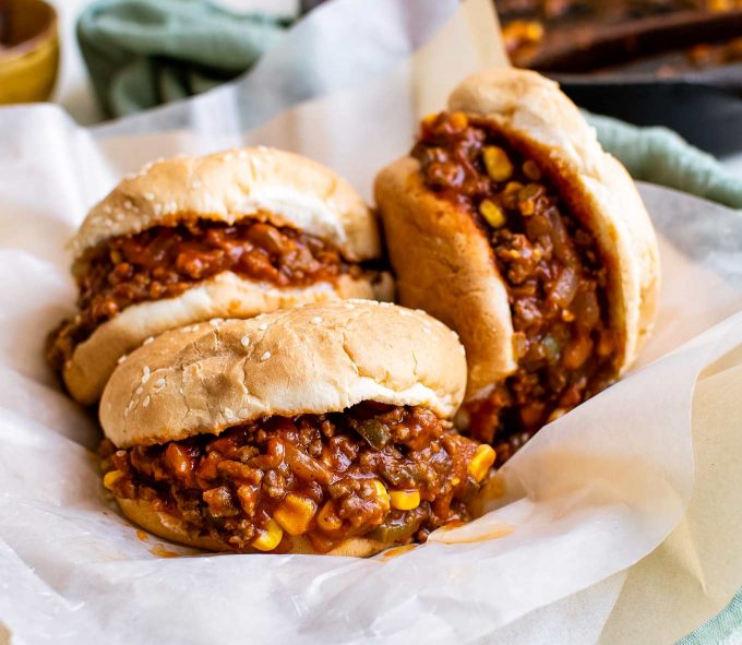 stack of sloppy joe sandwiches on parchment paper