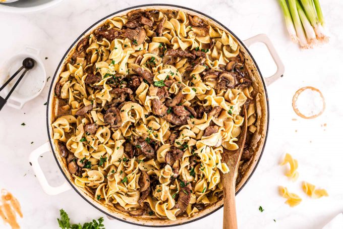 beef stroganoff in skillet with egg noodles