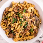 white bowl of beef stroganoff with spoon