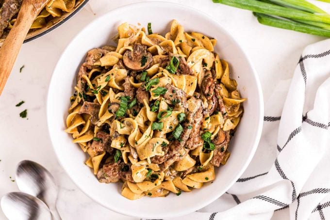 The Ultimate Beef Stroganoff is the most soul-warming comfort food around!  Tender beef strips, mushrooms and onions are smothered in a rich, beefy gravy and tossed with egg noodles.  Ready in about 30 minutes, it's a fabulous weeknight dinner option! #beef #beefstroganoff #stroganoff #comfortfood #dinner #weeknight #30minute #easyrecipe