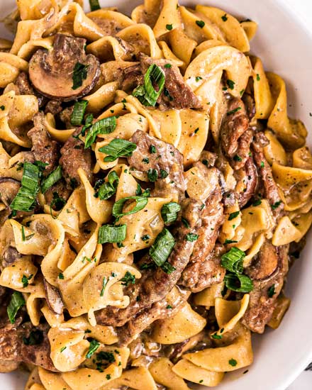 The Ultimate Beef Stroganoff is the most soul-warming comfort food around!  Tender beef strips, mushrooms and onions are smothered in a rich, beefy gravy and tossed with egg noodles.  Ready in about 30 minutes, it's a fabulous weeknight dinner option! #beef #beefstroganoff #stroganoff #comfortfood #dinner #weeknight #30minute #easyrecipe