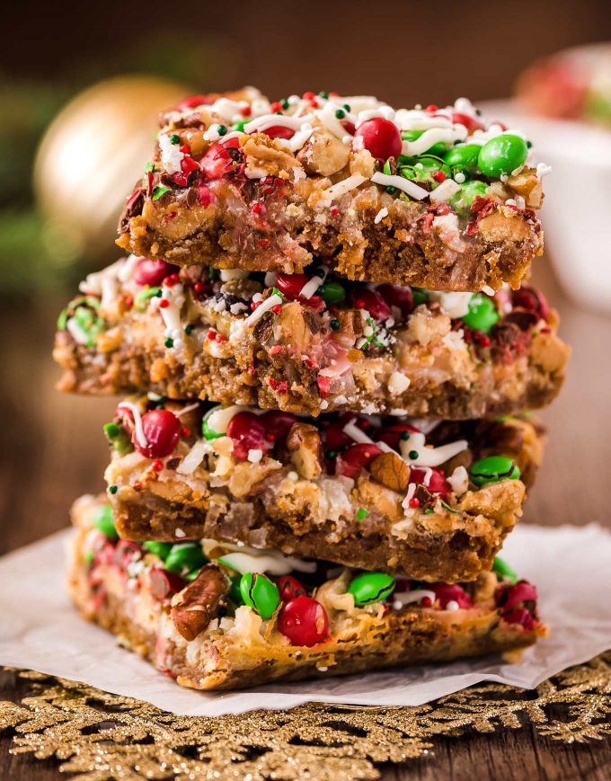 These easy Christmas 7 Layer Bars are great to make for the holidays!  Literally layer upon layer of deliciousness, this classic dessert goes by many names, such as magic cookie bars, hello dolly bars, etc... but no matter what you call them, they'll be a crowd-pleasing dessert! #7layerbars #magiccookiebars #hellodolly #kitchensink #sevenlayerbars #cookiebars #dessert #baking #holiday #christmas