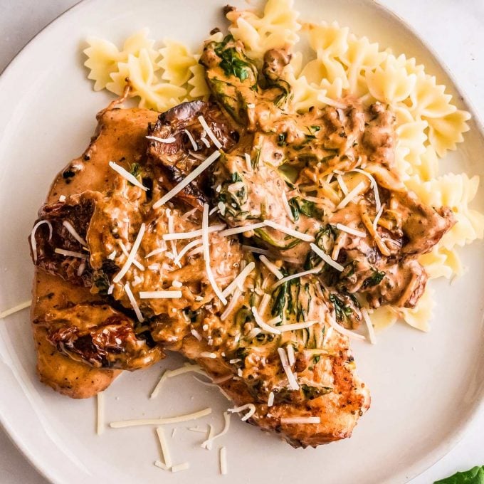 tuscan chicken on a plate with pasta