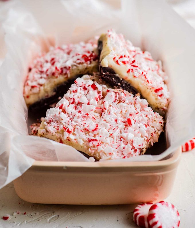 pile of homemade fudge in gift tin with peppermint