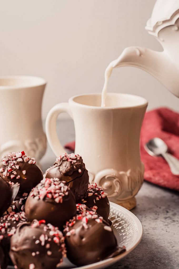 hot milk being poured into hot cocoa mug