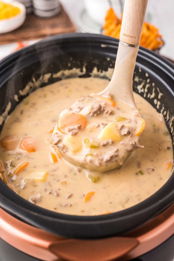 ladle of cheeseburger soup in slow cooker