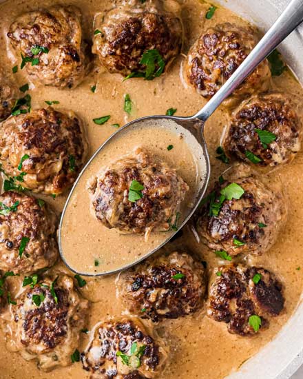 These Classic Swedish Meatballs are made with tender homemade meatballs in a rich and creamy brown gravy.  So simple to make, easy to prep ahead, and perfect to serve up to the family for dinner over some egg noodles or mashed potatoes! #meatballs #swedish #pork #beef #easyrecipe #dinner #comfortfood 