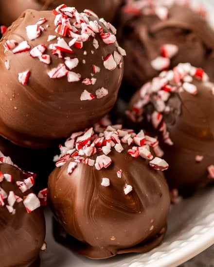 These Peppermint Mocha Hot Chocolate Truffle Bombs are the perfect no-bake treat!  Add one to a mug and pour hot milk over the top to make the most luscious hot chocolate ever! Using simple ingredients, you can have these whipped up in no time!#truffles #chocolate #holidayrecipes #christmas #hotchocolate #dessertrecipe #easydessert #trufflerecipes #hotcocoa  #holiday #easyrecipe #hotchocolatebombs
