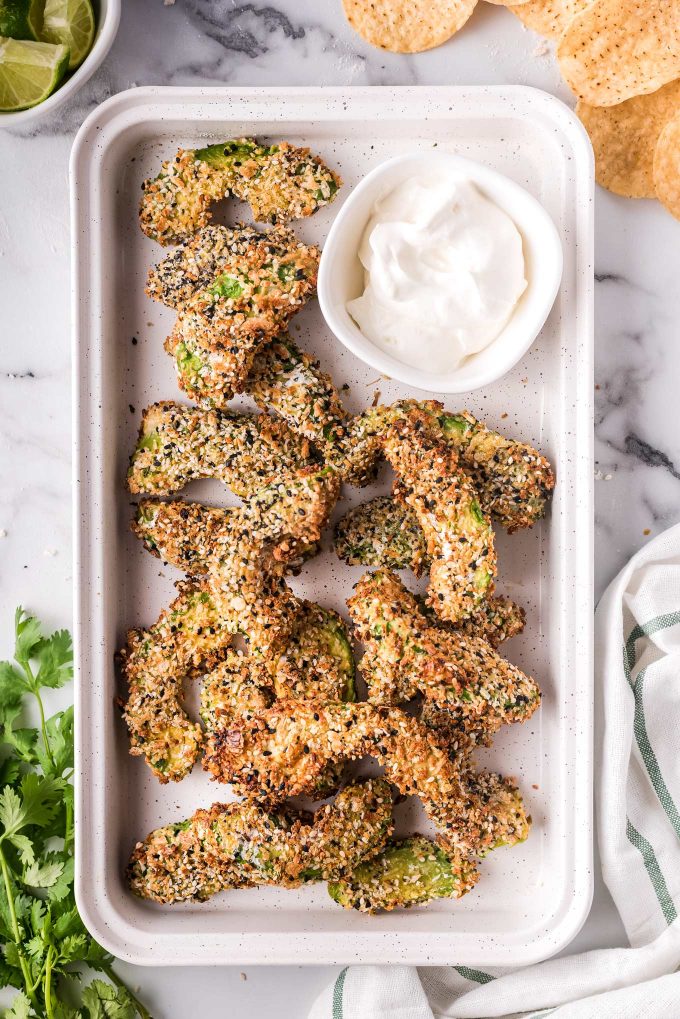 These everything bagel seasoned avocado fries are cooked in the air fryer and are a healthy and super easy side dish/appetizer.  Perfectly crispy on the outside and so creamy in the middle, they're great on their own with a dipping sauce, or as a topping on a burger or sandwich! #airfryer #airfryerrecipe #avocado #avocadorecipe #avocadofries #friedavocado #snack #appetizer